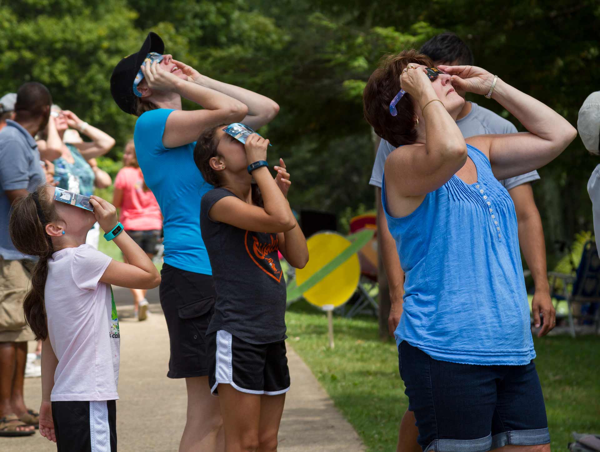 group of people watching an eclipse with eclipse glasses